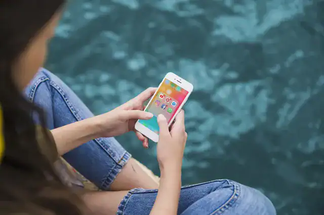 young woman using phone with social media apps