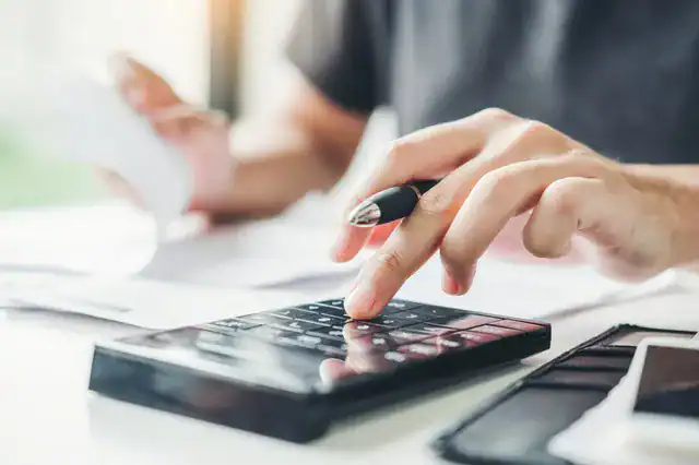 business person calculating price